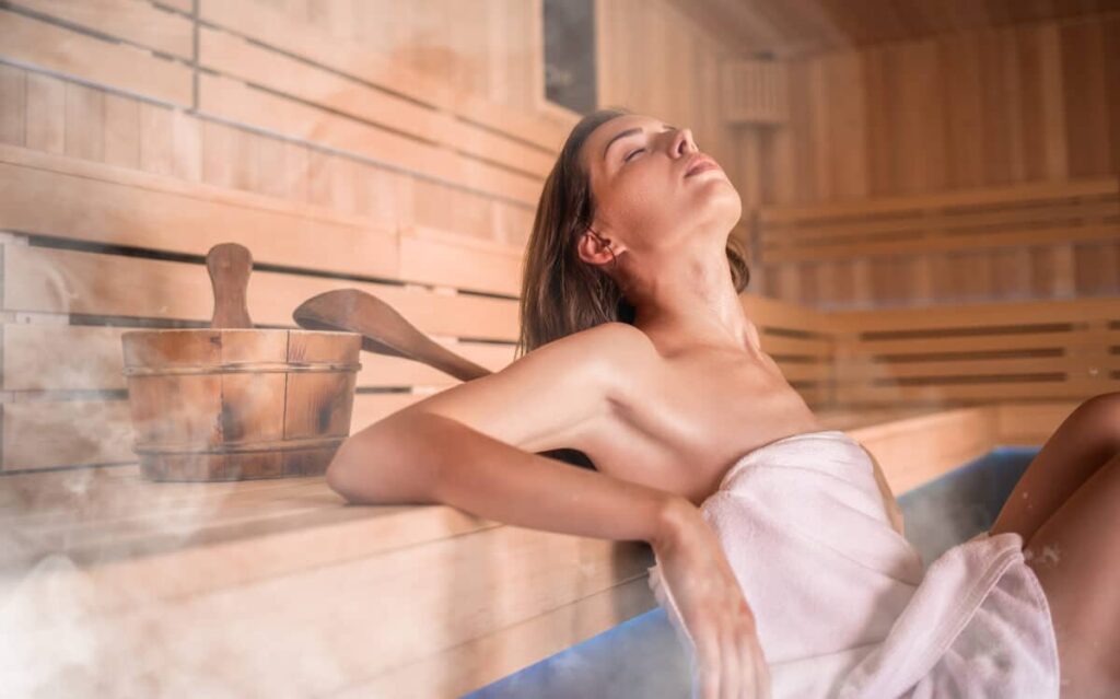 Young woman relaxing in a sauna