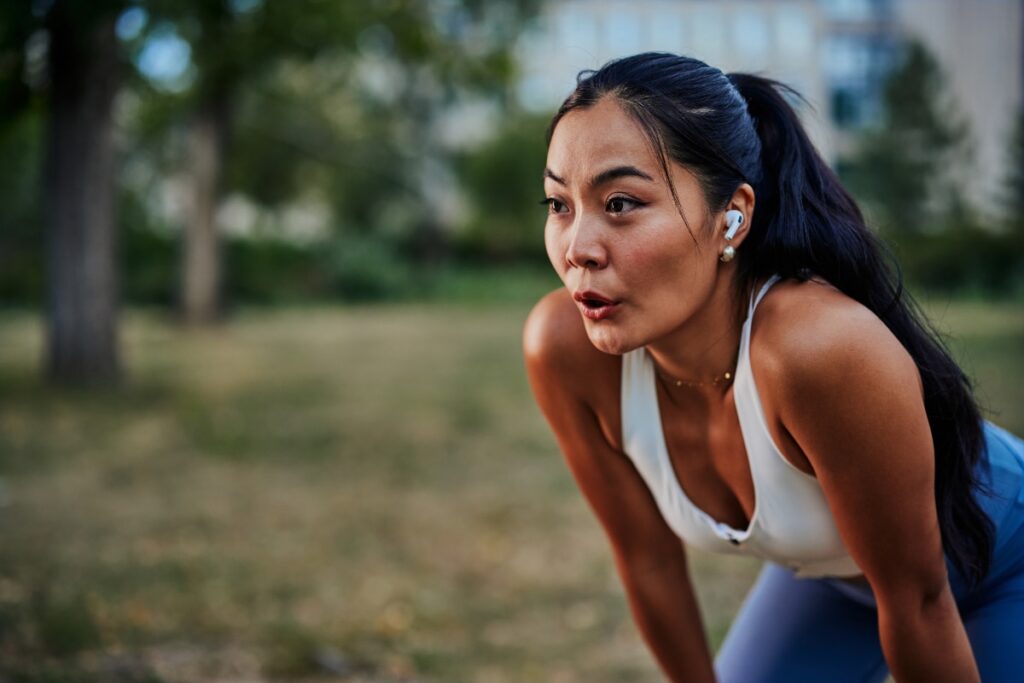 Woman taking a moment to catch her breath before cold plunge session
