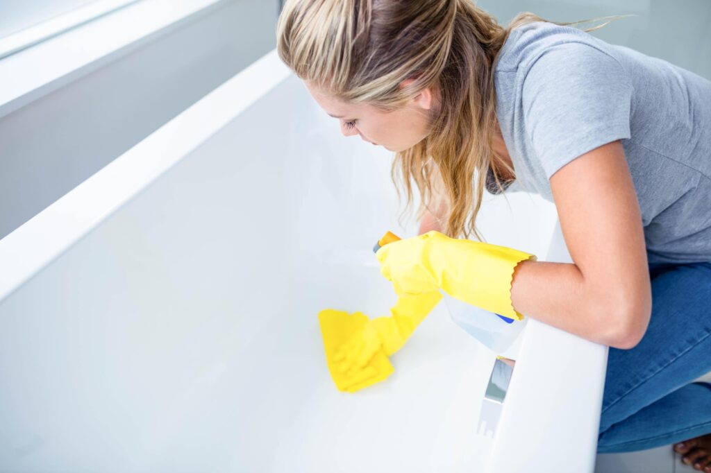 Woman cleaning cold plunge tub