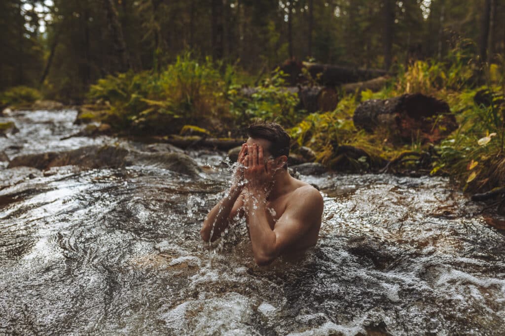 Young man cold plunging in a Utah river
